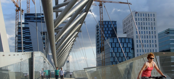 Woman, boys and dog cross a bridge at Bjørvika, Oslo