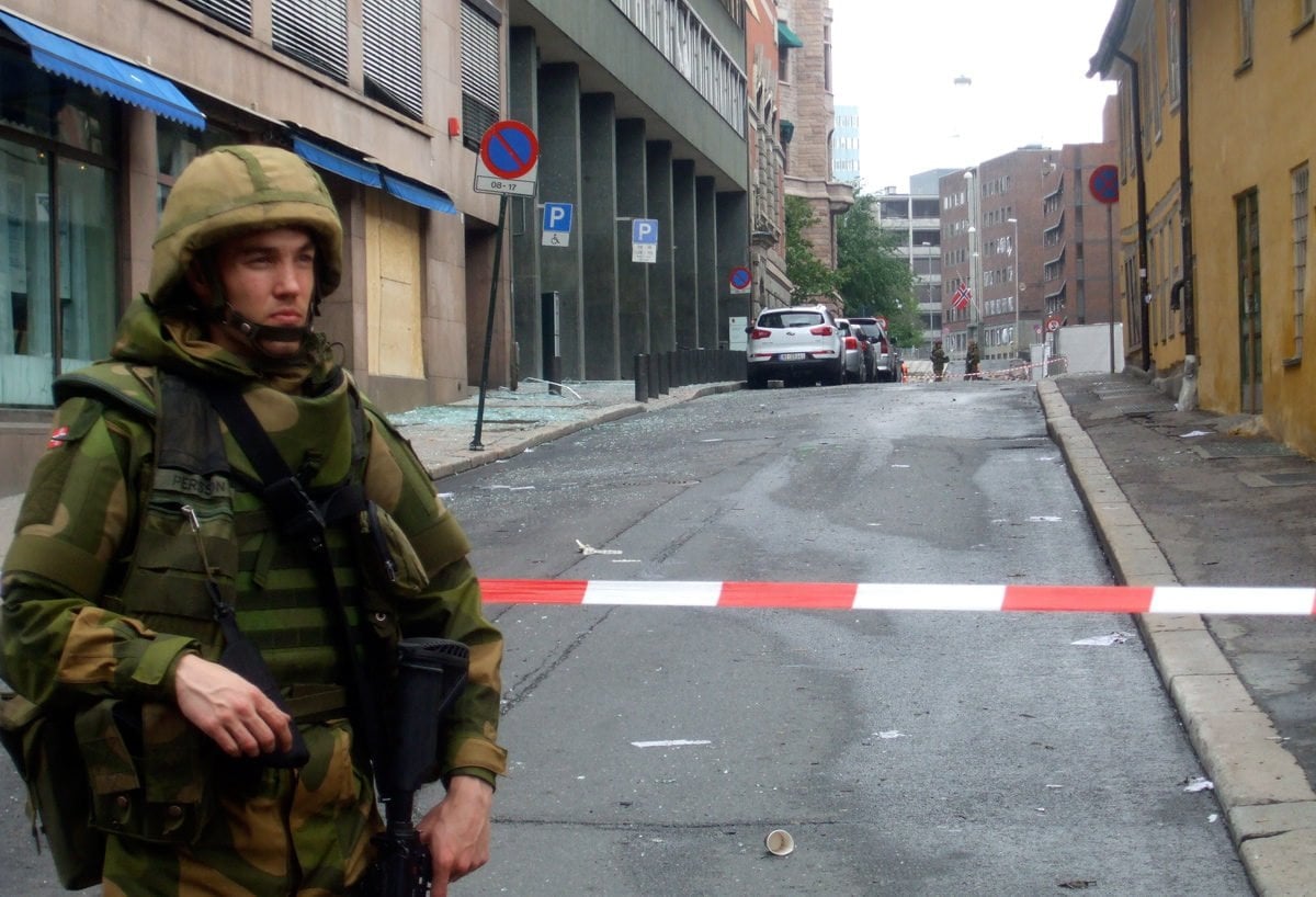 An armed soldier stands guard following the Oslo bomb