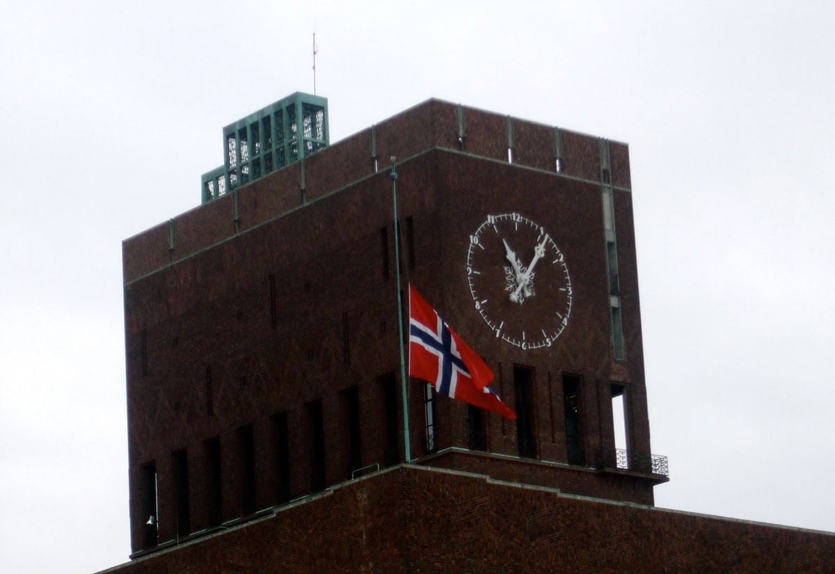 Oslo City Hall flying the Norwegian flag at half-mast