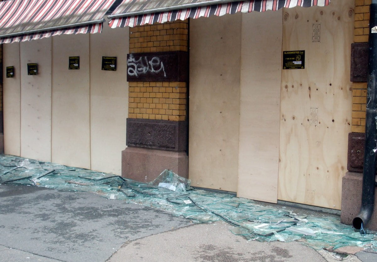 A shop with its glass windows blown out following the Oslo bombing