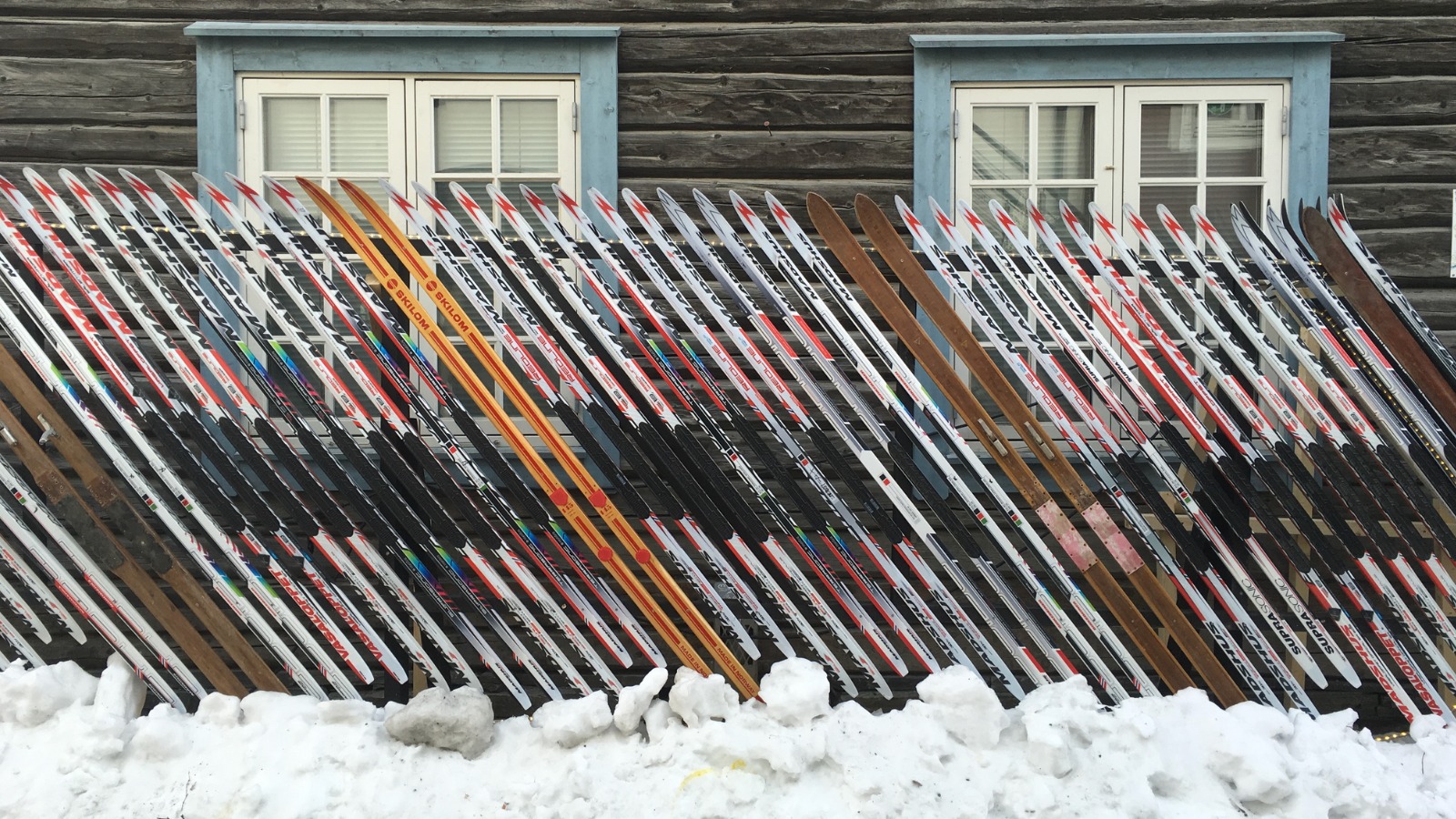 Skis outside a wooden building in the snow in Lillehammer, Norway. Photo: David Nikel.