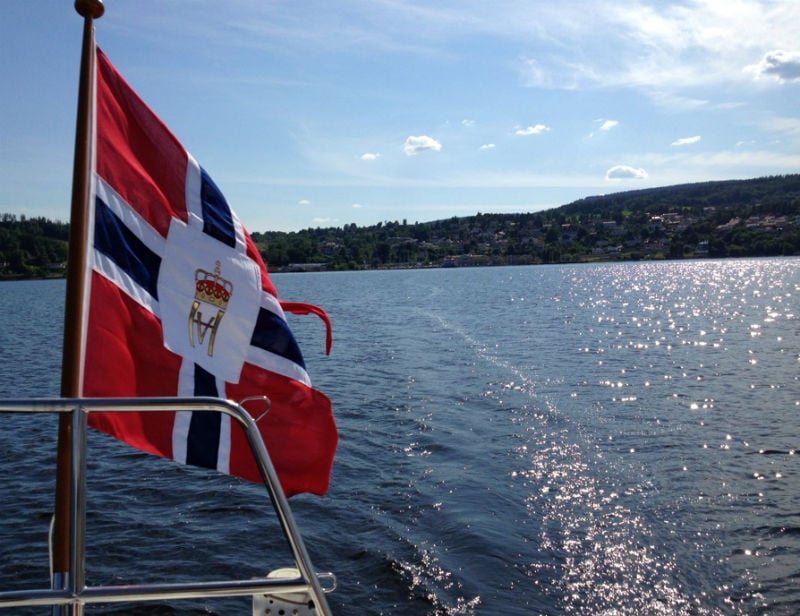 Norwegian flag over the water