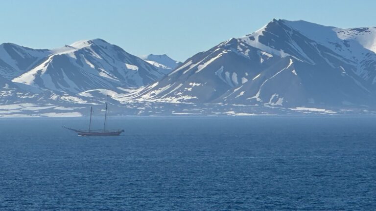 Historic sailing boat against the spectacular landscape of Svalbard. Photo: David Nikel.