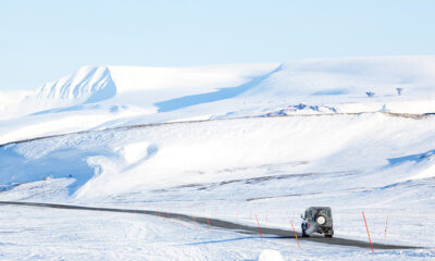 A car driving through the snowy mountains of Norway