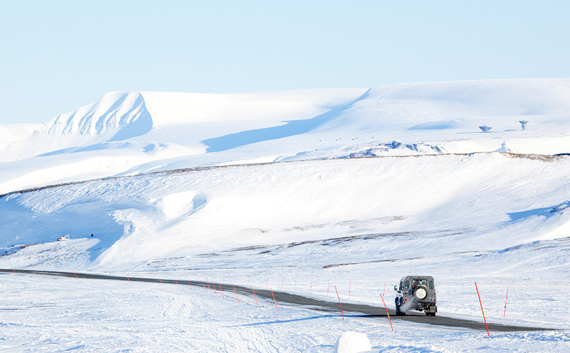 A car driving through the snowy mountains of Norway