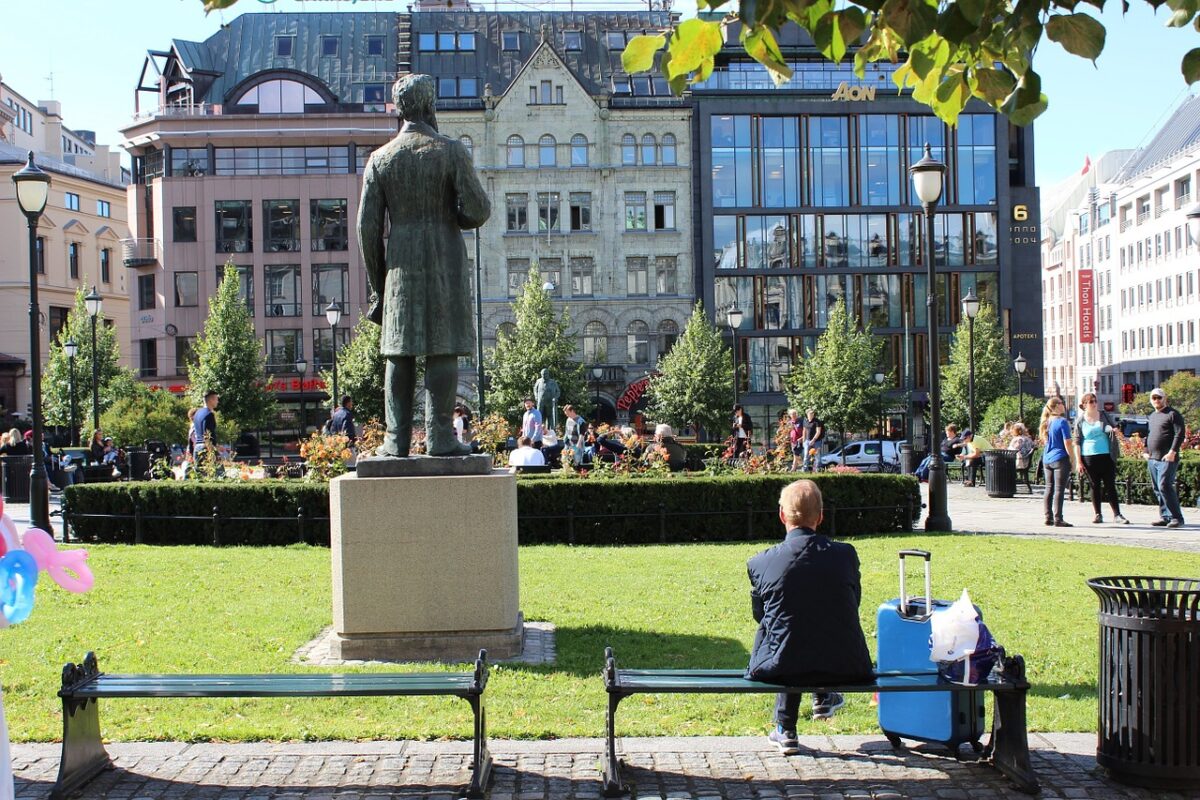 Norwegian sitting on a bench facing away from the camera.