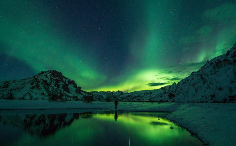 A bright green aurora borealis display in Norway