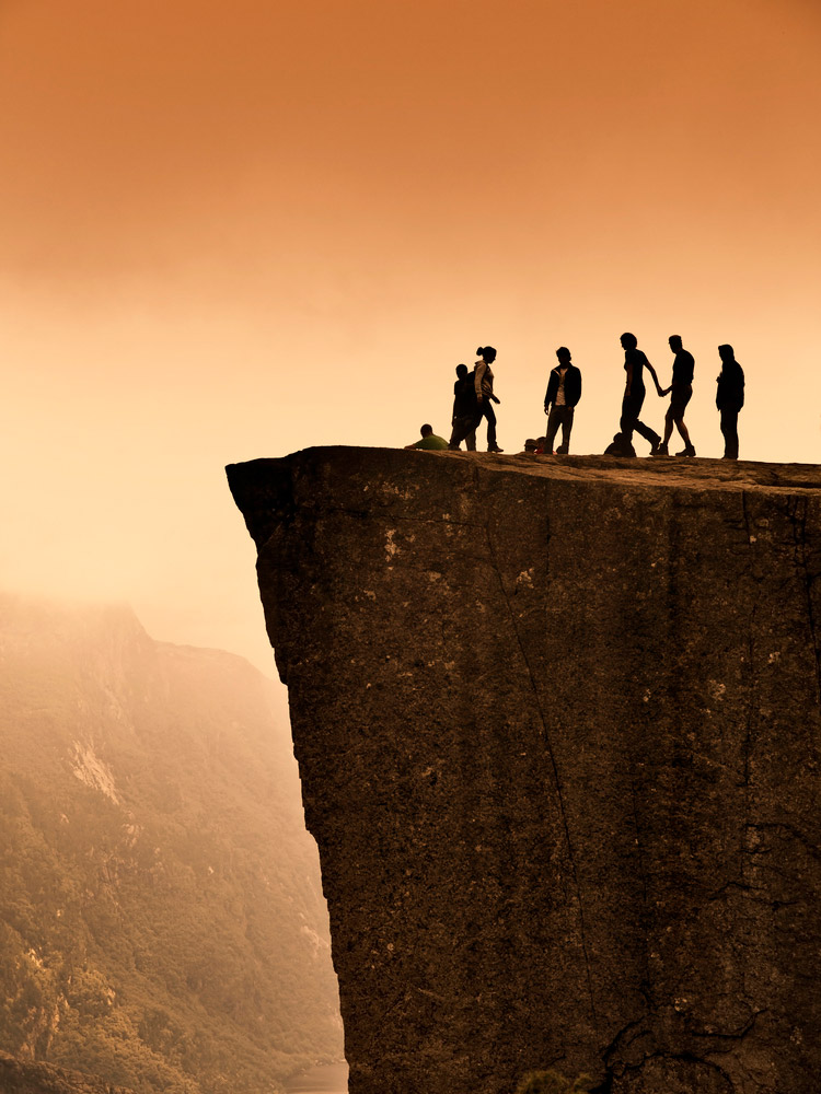 Tourists standing on Preikestolen or Pulpit Rock in Norway.