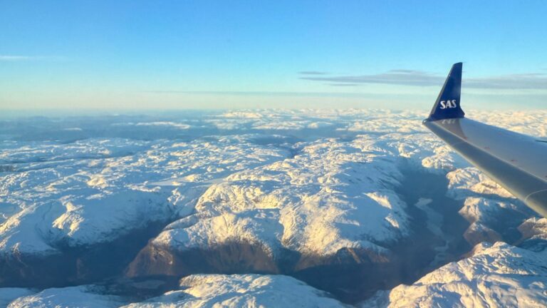 View across snowy mountains from a SAS airplane in Norway. Photo: David Nikel.