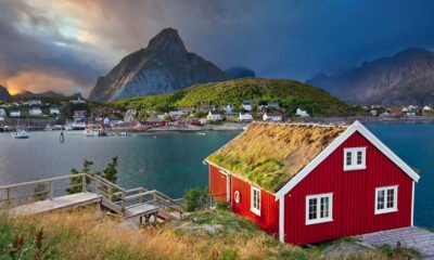 Red cabin in Norway with the Lofoten mountains in the background