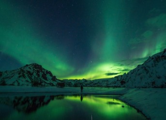 A bright green aurora borealis display in Norway