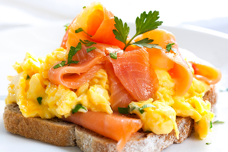 A scrambled egg and smoked salmon sandwich