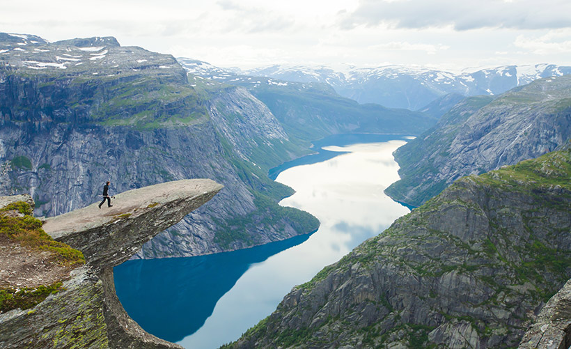 Best Norway hike. Cute girl with hiking equipment in the mountains