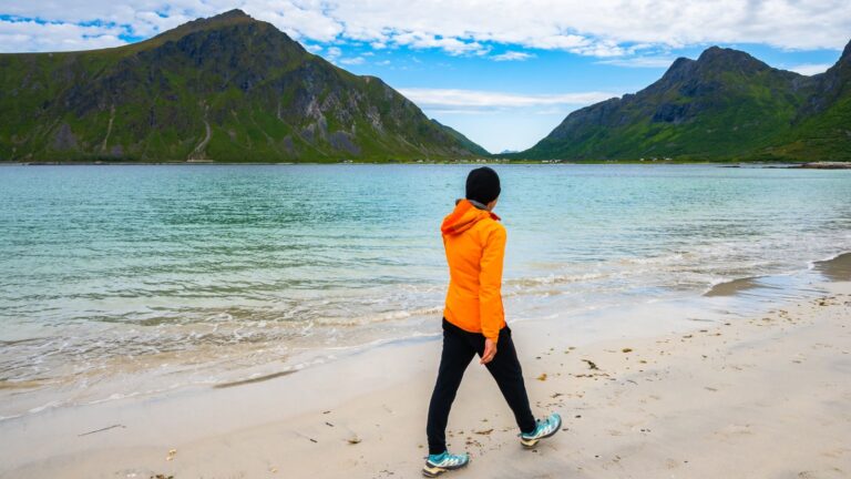 Person walking on Skagsanden beach in Lofoten, Norway.