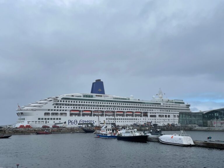 Inner harbour of Trondheim with an autonomous vessel in front of a large cruise ship. Photo: David Nikel.