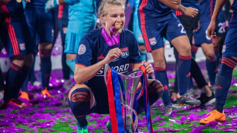 Norwegian footballer Ada Hegerberg celebrating with the UEFA Champions League trophy while playing for Olympique Lyonnais. Photo: Mikolaj Barbanell / Shutterstock.com.