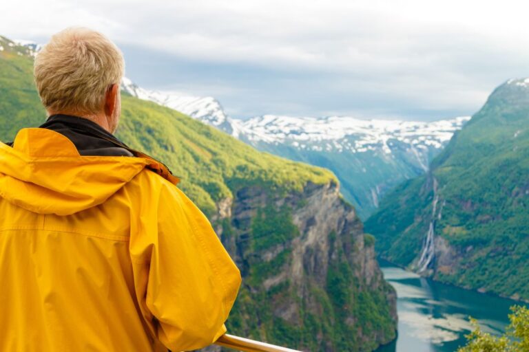 Man at fjord viewpoint in Norway.