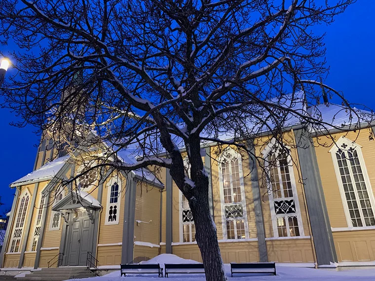 The beautiful wooden cathedral of Tromsø bathed in winter blue light