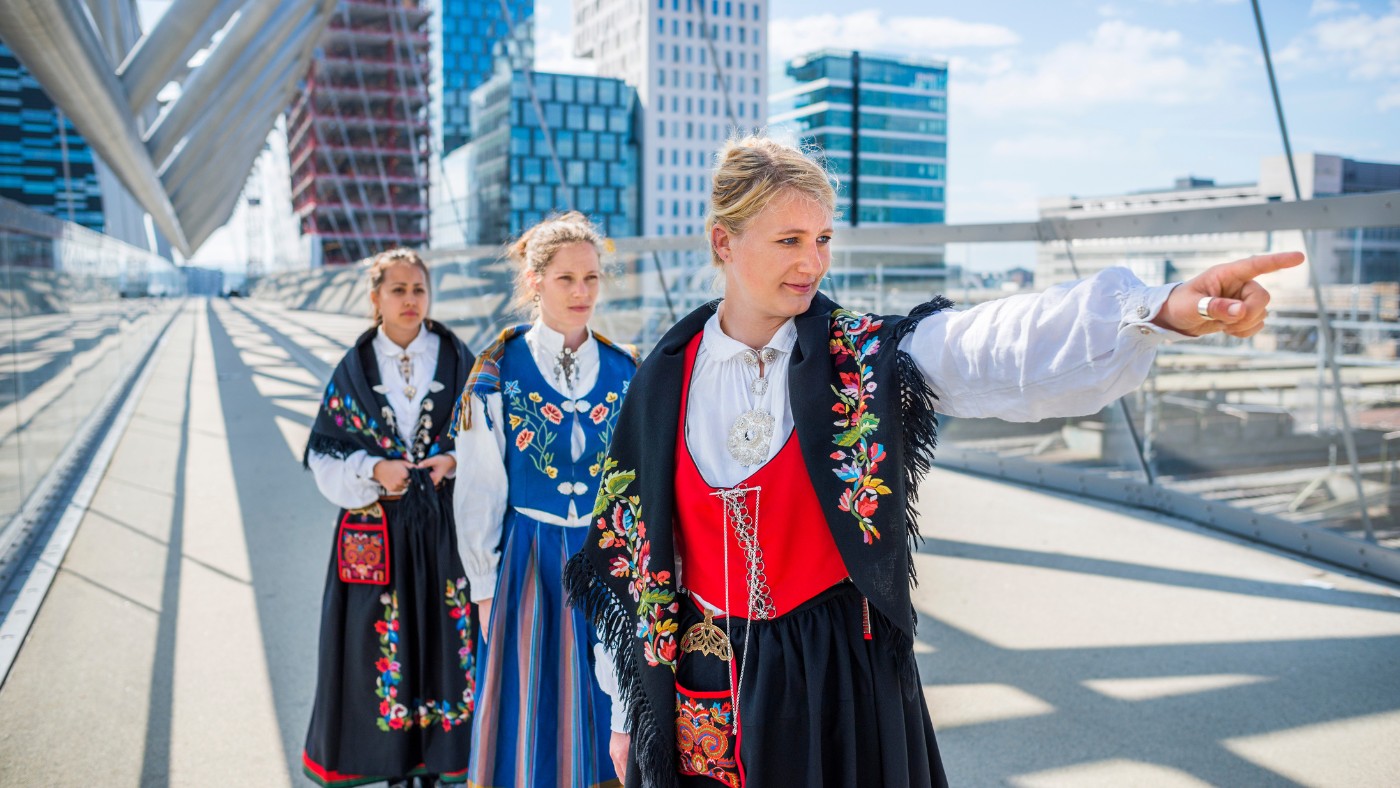Three young women wearing the Norwegian bunad in Oslo, Norway. Photo: Frederik Tellerup / Shutterstock.com.