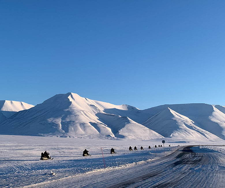 A snow scooter highway next to the road just outside Longyearbyen on Svalbard, Norway