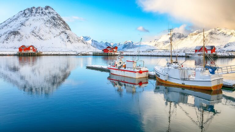 Fishing boats in the Lofoten Islands with a winter landscape.