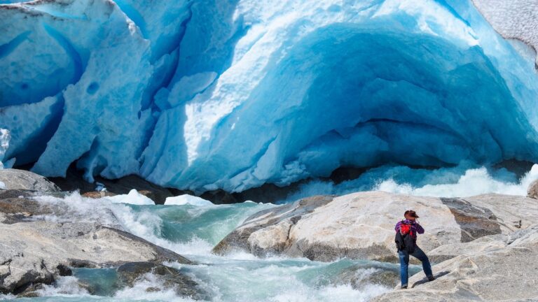 Photographer at Nigardsbreen glacier arm in Norway.