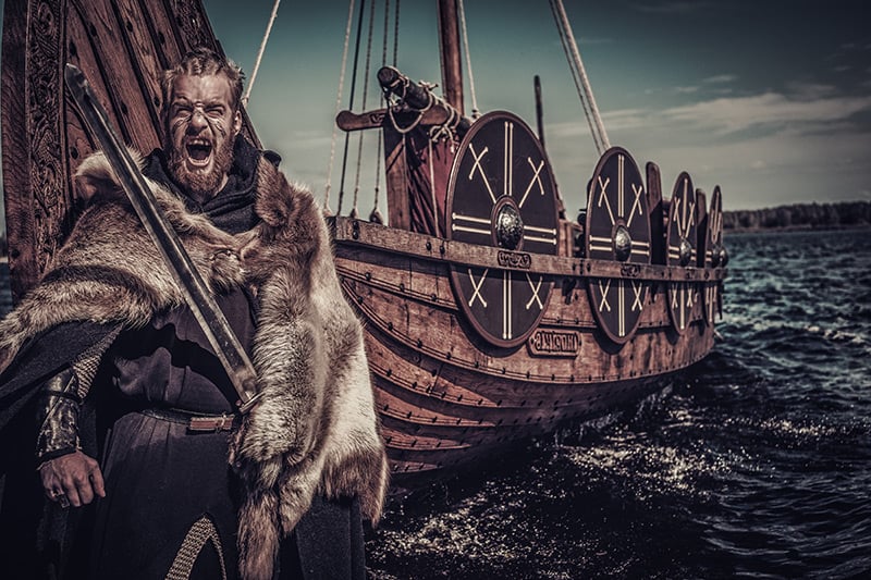 Viking raider with a longship