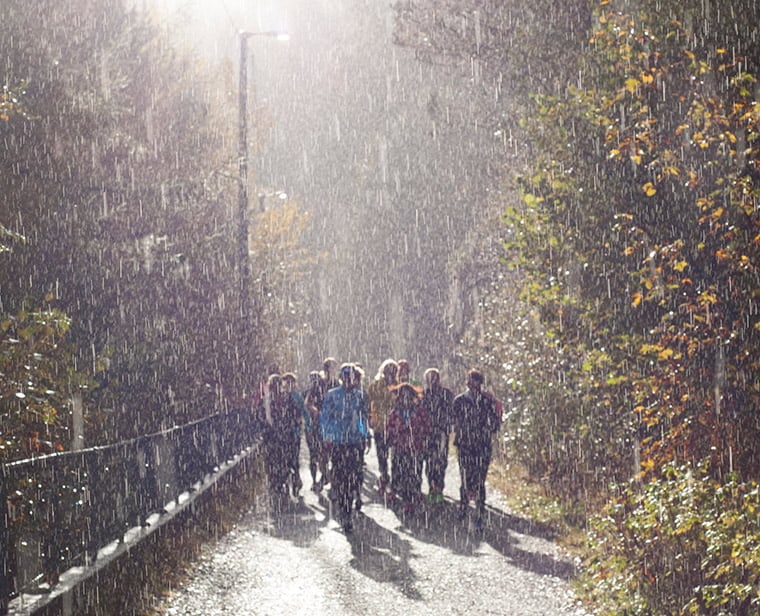People hiking through Bergen in the rain
