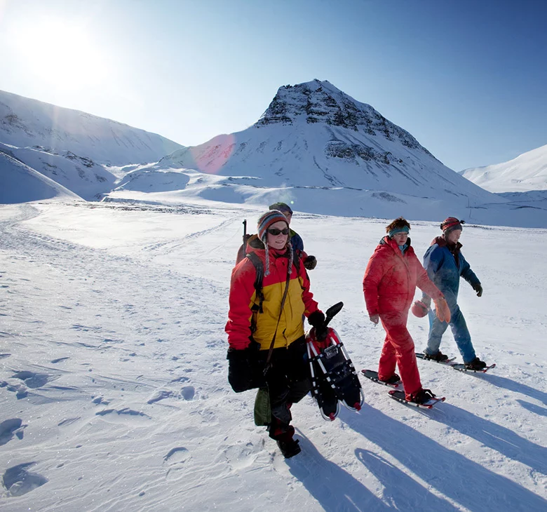 A tour group exploring the landscape of Svalbard