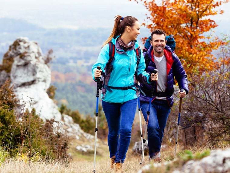 A couple Nordic walking in the countryside