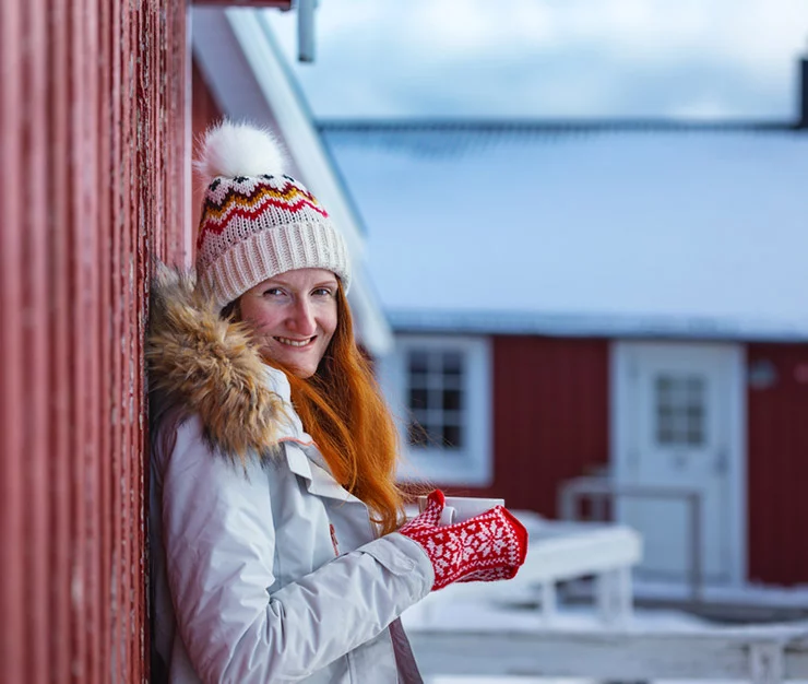 A Norwegian woman wearing knitted hat and mittens