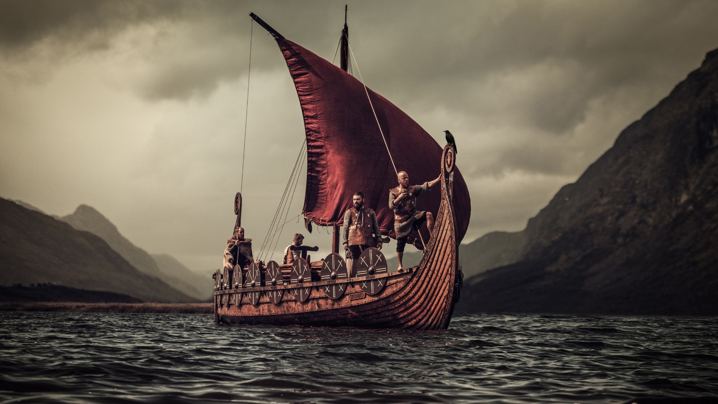 Viking ship with members of a reenactment group on a Norwegian fjord.