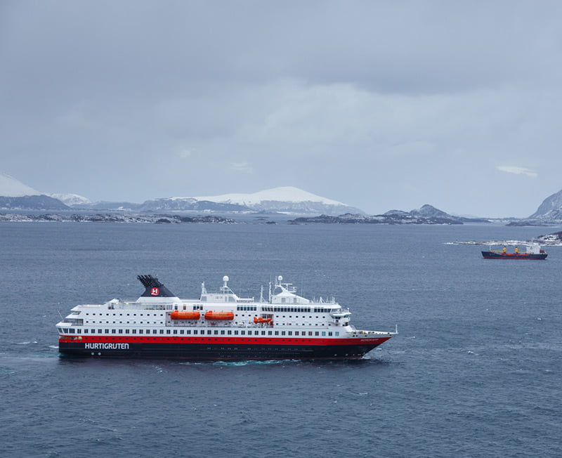 A Hurtigruten vessel on the water during a Norwegian winter