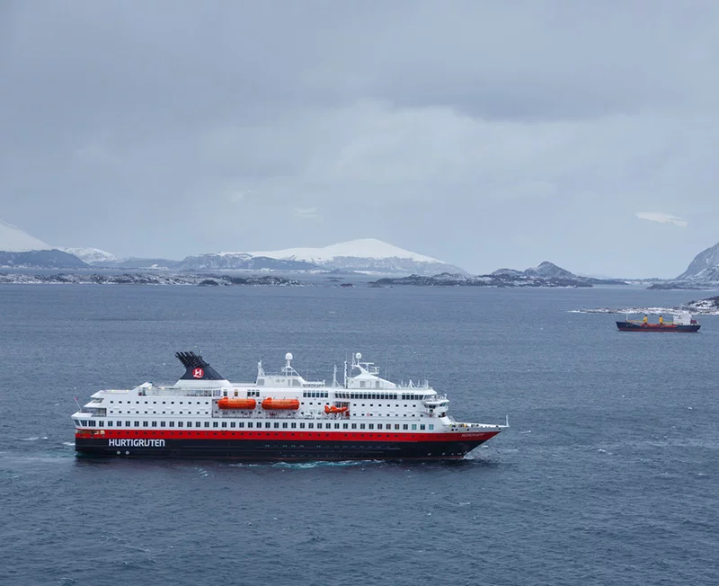 A Hurtigruten vessel on the water during a Norwegian winter