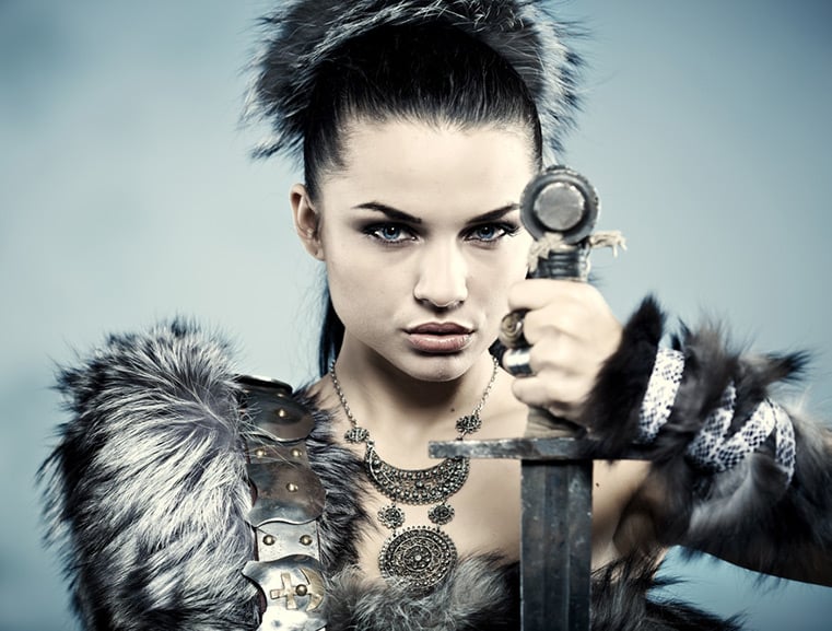 A fashion shoot of a Viking woman with sword