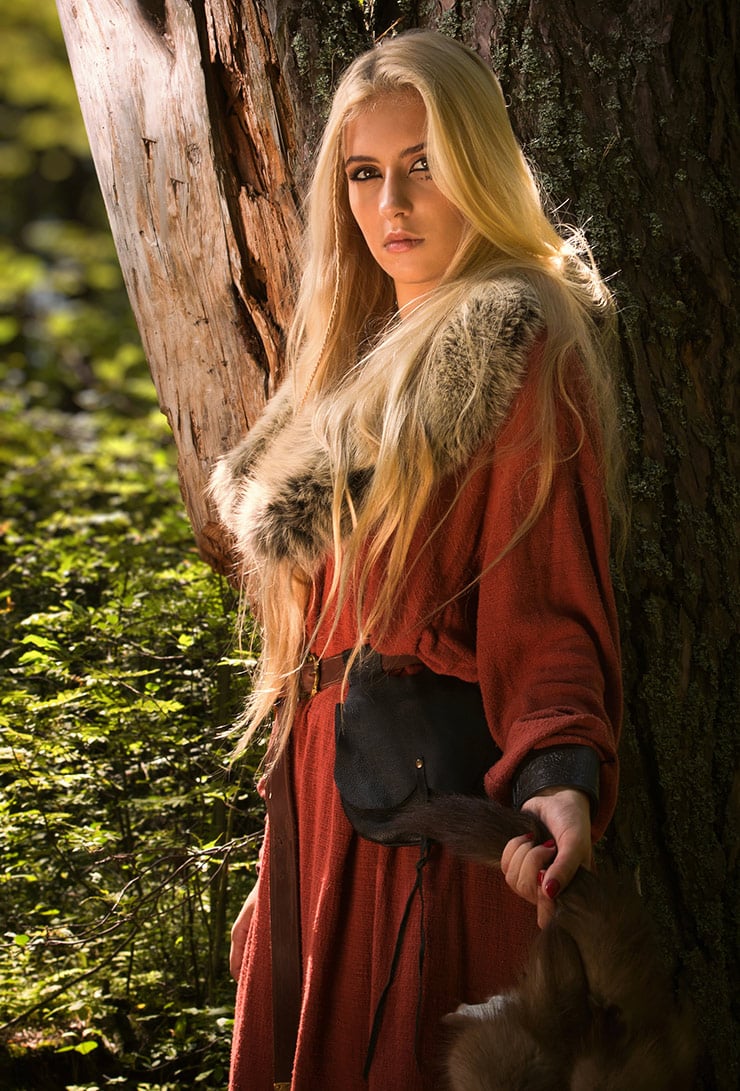 Woman posing as a Viking in bright red clothing and furs