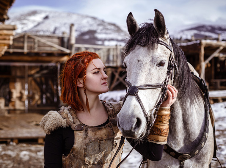 Viking woman with horse on a Scandinavian farm