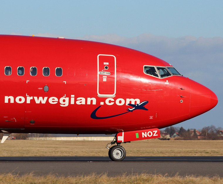 The iconic red nose of a Norwegian Air airplane