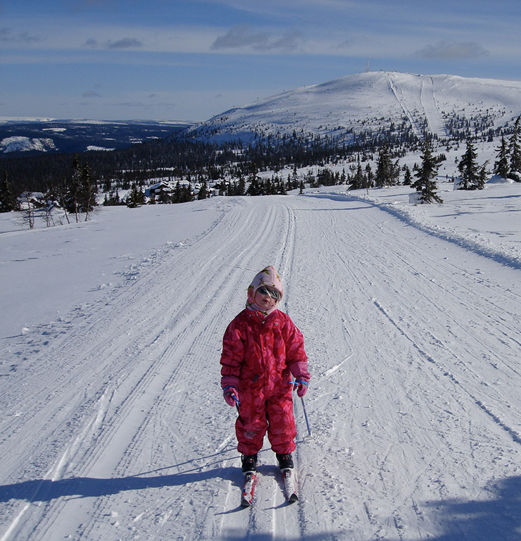 A young child cross-country skiing in Norway