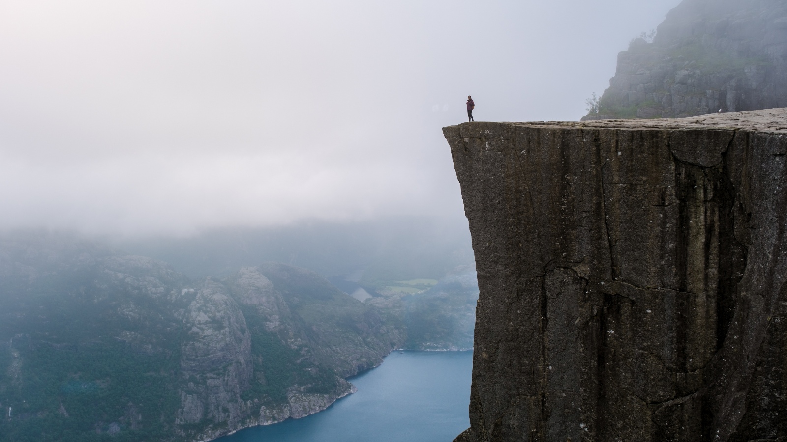 Hiker standing on Pulpit Rock in Norway.