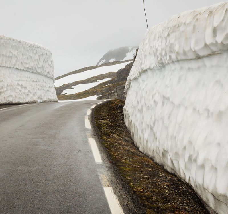 Cliffs of snow line the Aurlandsfjellet snow road in western Norway