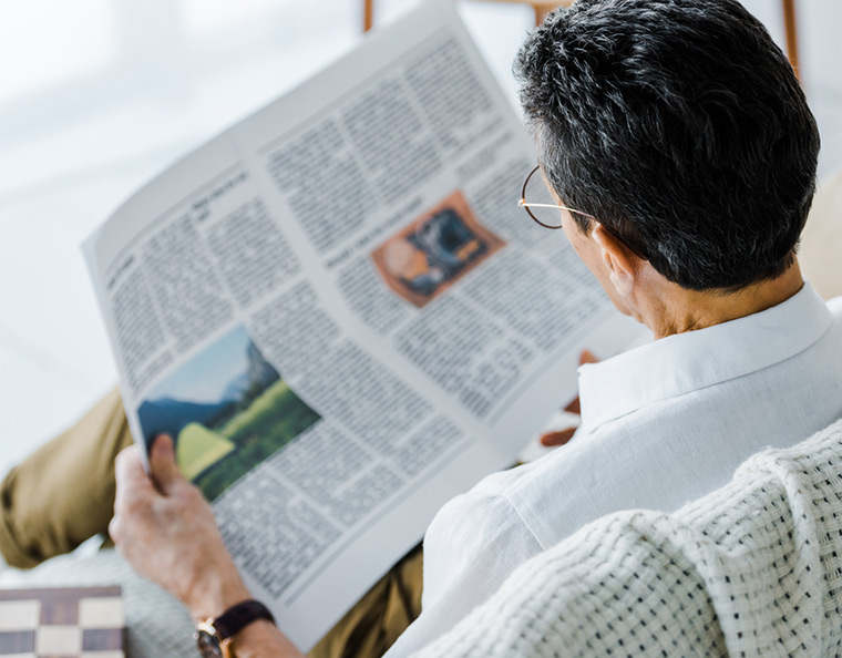 Man reading a newspaper in Norway