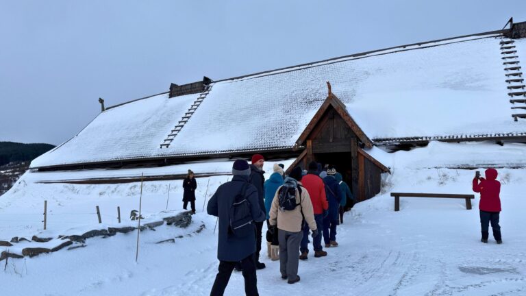 Visitors entering the longhouse at Lofotr Viking Museum in Lofoten. Norway. Photo: David Nikel.