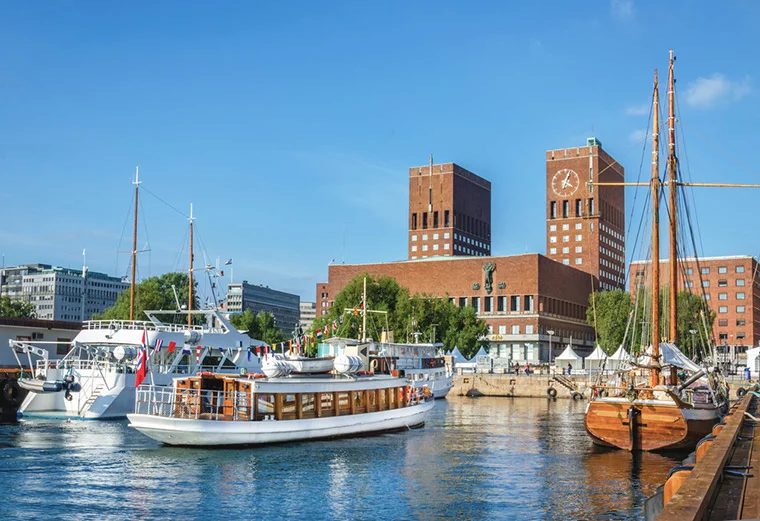 Oslo city hall and boats in the harbour in good weather