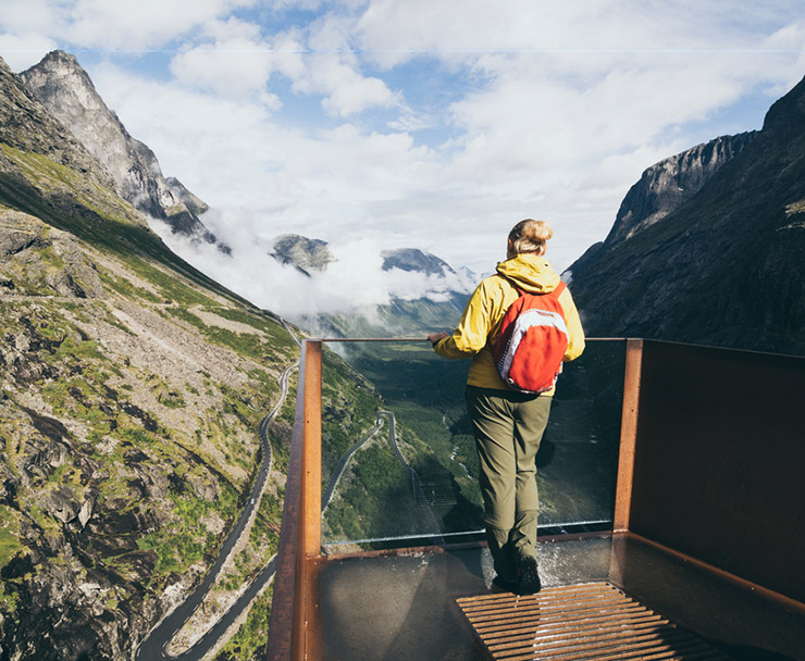 Scandinavian woman standing at one of the Trollstigen road viewpoints