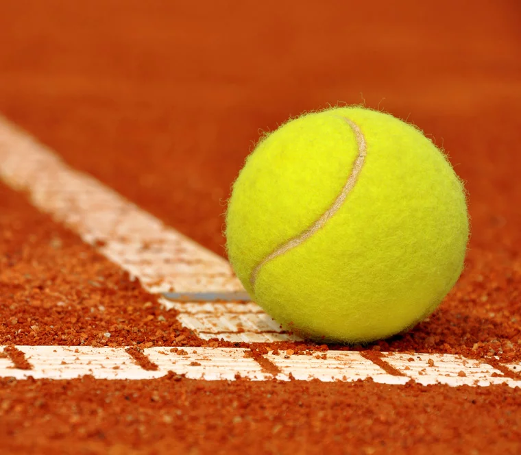 Tennis ball on a clay court