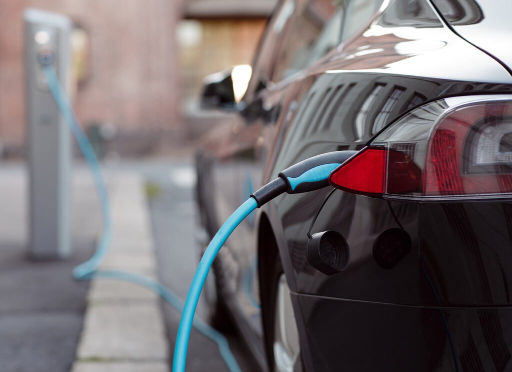 Electric car charging on a street.