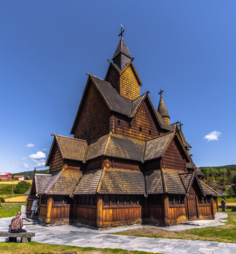 A man sitting outside Norway's Heddal wooden church