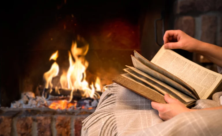 Reading a Norway book by the fireplace