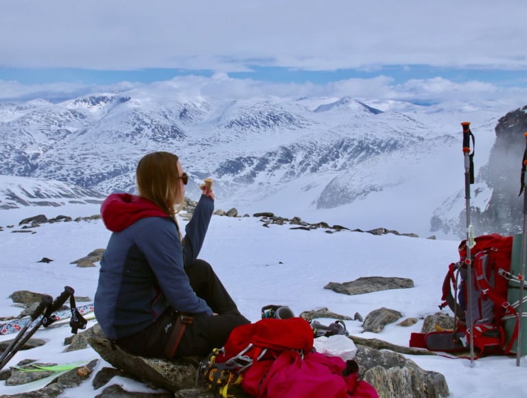 A hiker taking a break on a Norwegian mountain.
